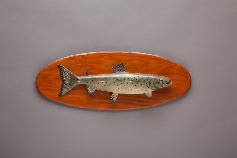 Land-Locked Salmon: Land-Locked Salmon Lawence Irving (1918-1998) Winthrop, ME, c. 1960 Original paint. A fifteen-inch-long salmon carving on a naturally stained plywood beveled edge plaque. "Salmon" is written on the ba