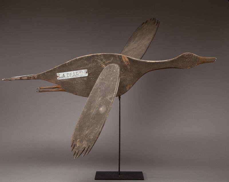 Goose or Over-Sized Black Duck Weathervane: Goose or Over-Sized Black Duck Weathervanec. 1900 A thirty-five-inch-long, one-inch-thick silhouette weathervane with whirligig moveable wings attached. On one side a remaining metal name plate reads 