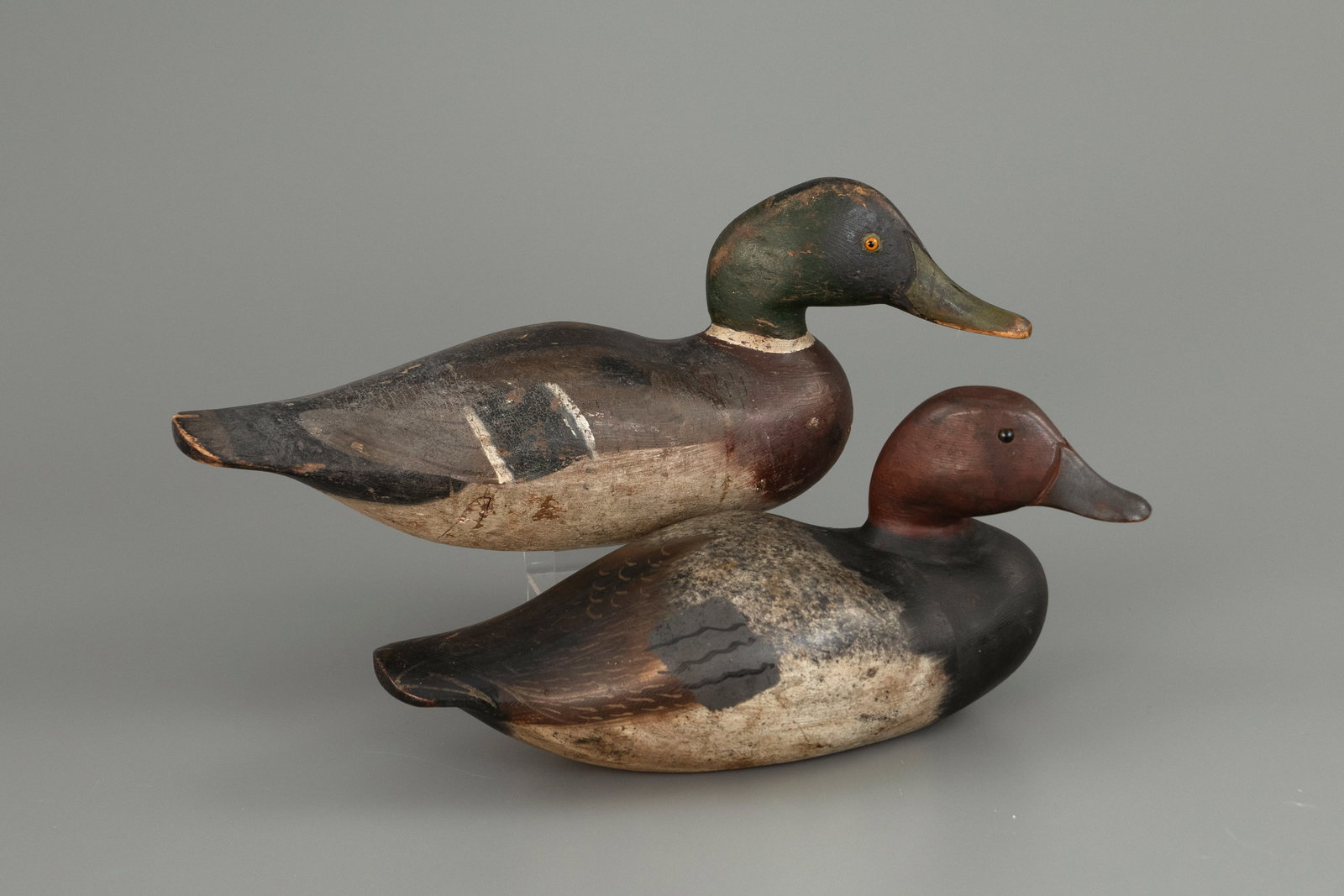 One Mallard and One Redhead by J. N. Dodge Factory (1883-1893): One Mallard and One Redhead J. N. Dodge Factory (1883-1893) Detroit, MI 17 1/4 in. long Original paint with moderate gunning wear, both have restoration to necks. Condition Original paint with moderat
