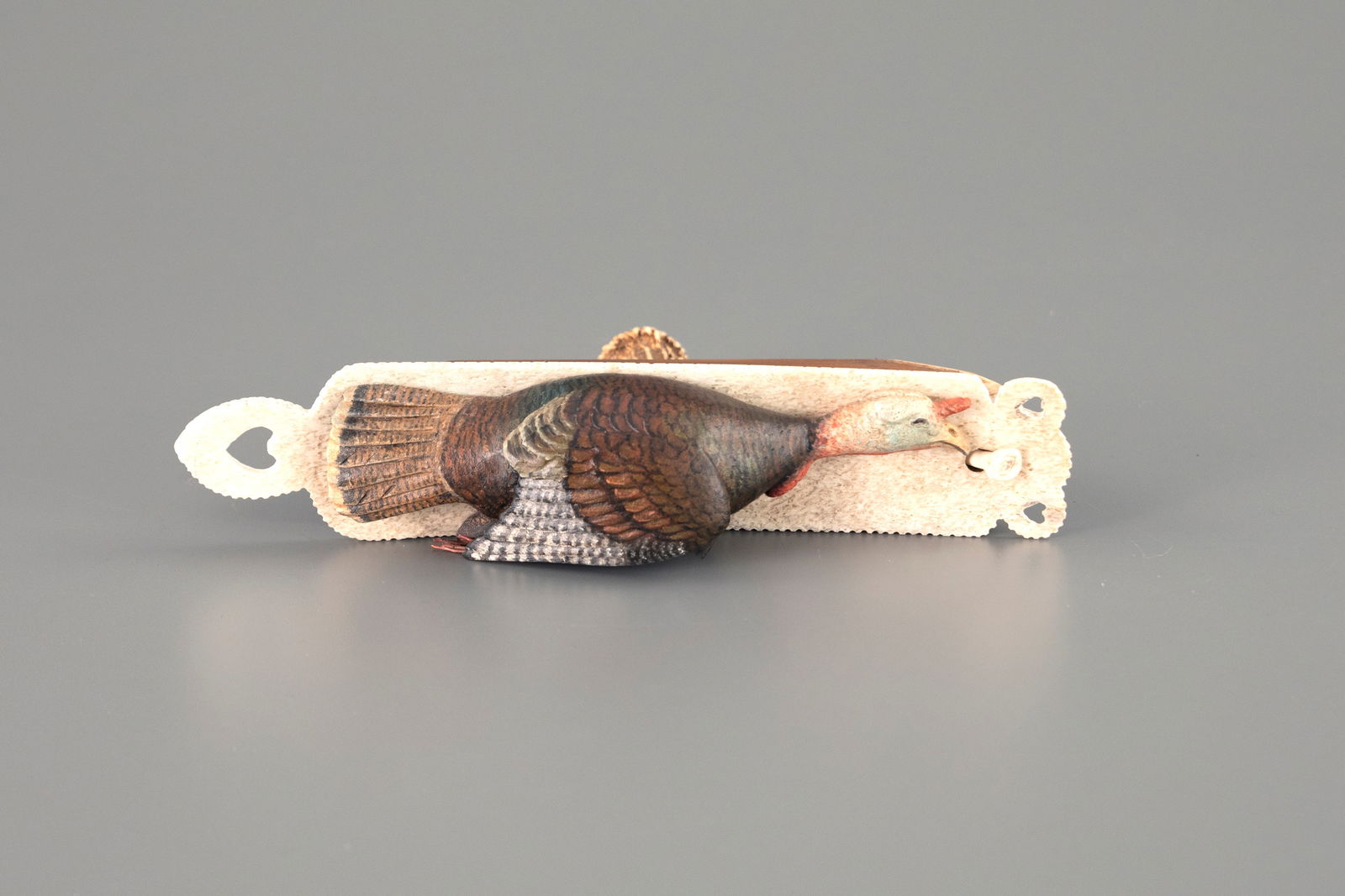 Turkey Box Call by Frank S. Finney (b. 1947): Turkey Box Call Frank S. Finney (b. 1947) Capeville, VA 9 1/2 in. long This rare work is constructed from wood, bone, and antler, the beard is horsehair. The turkey carving displays incised feather de