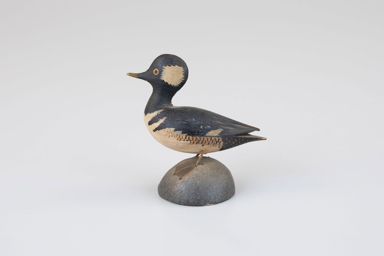 Miniature Hooded Merganser by A. Elmer Crowell (1862-1952): Miniature Hooded Merganser A. Elmer Crowell (1862-1952) East Harwich, MA, c. 1910 3 in. tall This carving is inscribed "Hooded Merganser" and very faintly bears Crowell's circular "MFR" ink stamp on i