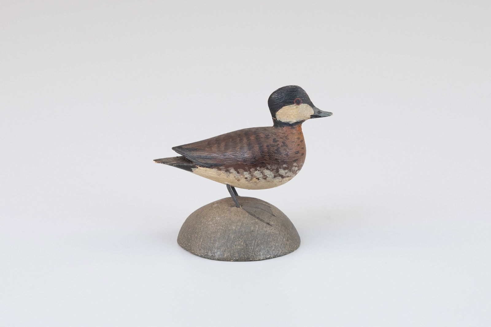 Miniature Ruddy Duck by A. Elmer Crowell (1862-1952): Miniature Ruddy Duck A. Elmer Crowell (1862-1952) East Harwich, MA, c. 1910 2 1/2 in. long A rare early miniature with Crowell's circular "MFR" ink stamp on its white underside. Original paint with li