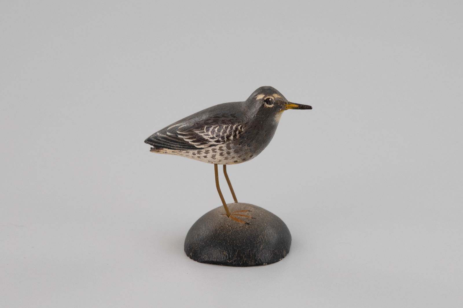Miniature Purple Sandpiper by A. Elmer Crowell (1862-1952): Miniature Purple Sandpiper A. Elmer Crowell (1862-1952) East Harwich, MA, c. 1930 2 3/4 in. tall The underside is signed by the maker with his rectangular stamp. It is also painted black and debossed
