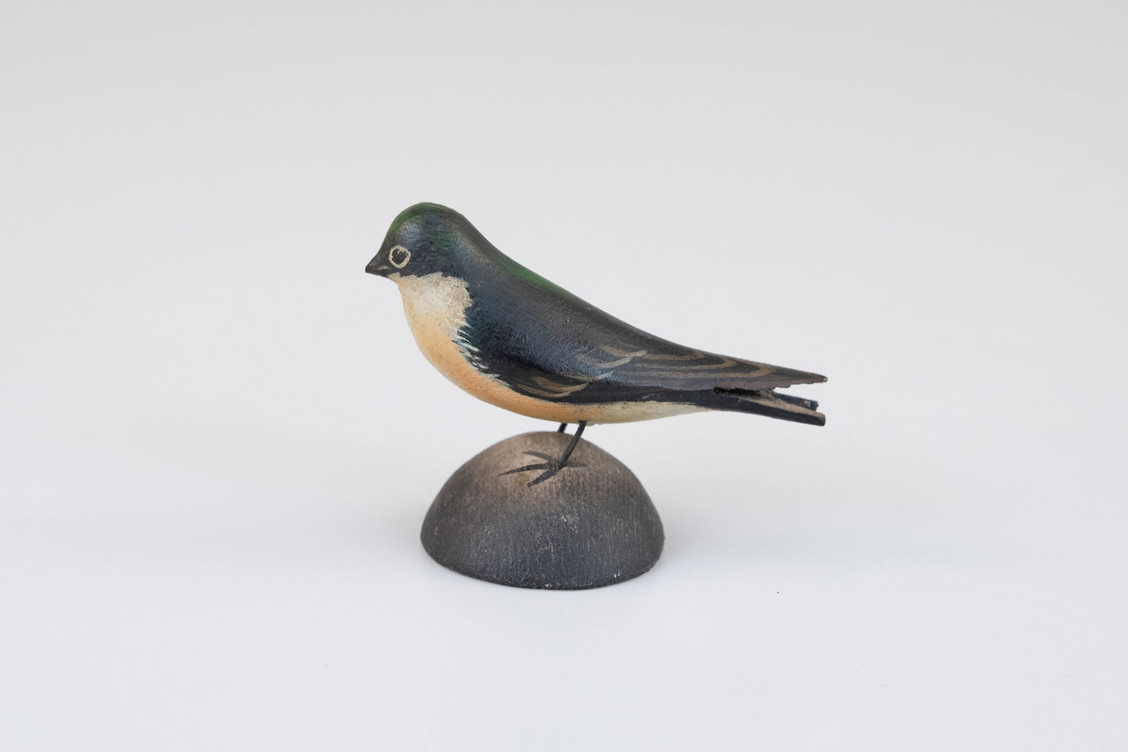 Miniature Swallow by A. Elmer Crowell (1862-1952): Miniature Swallow A. Elmer Crowell (1862-1952) East Harwich, MA, c. 1920 1 3/4 in. tall This carving is inscribed "Barn Swallow" and bears Crowell's circular "Maker" ink stamp on the underside. Origin