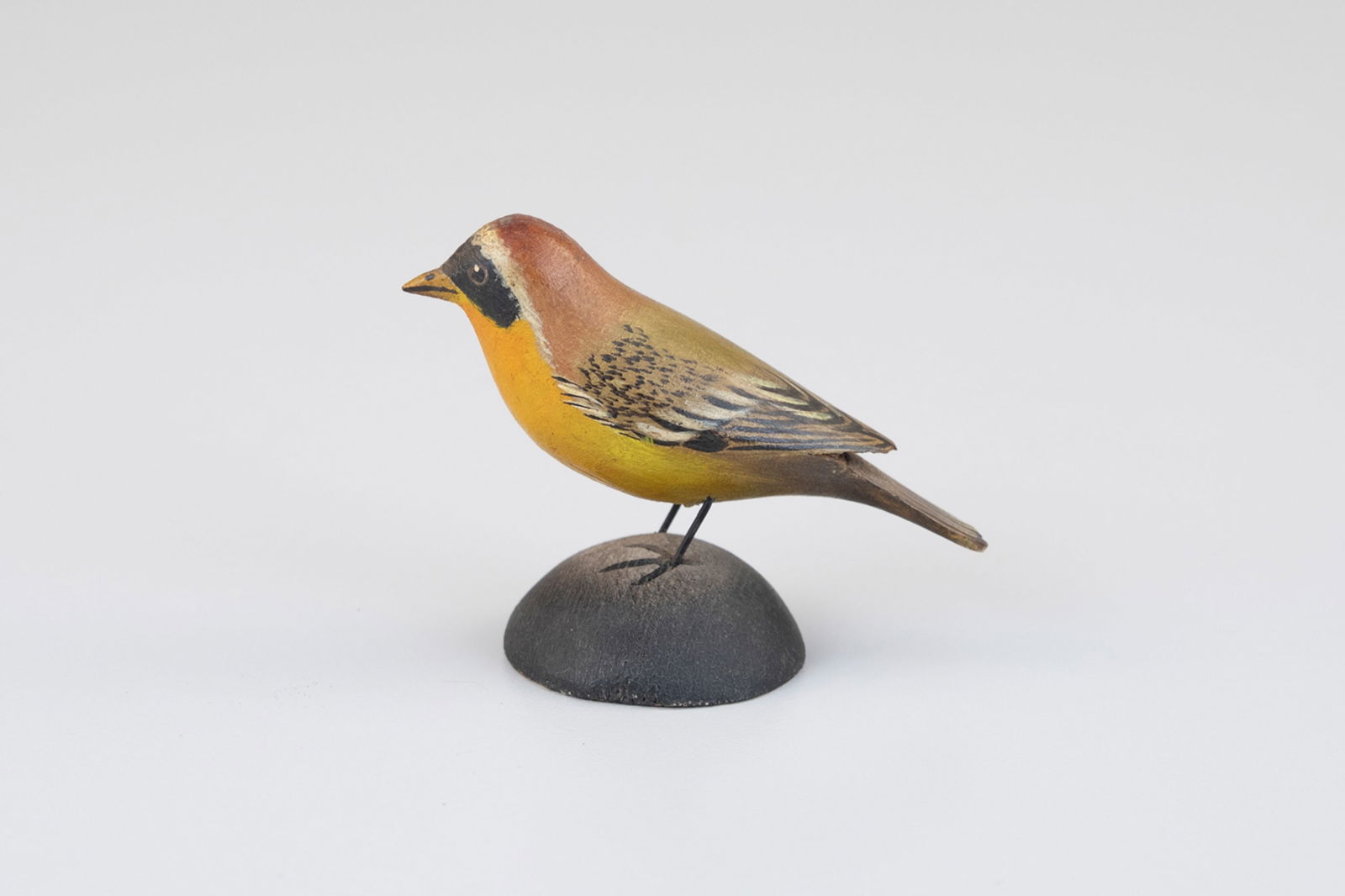 Miniature Maryland Yellowthroat by A. Elmer Crowell (1862-1952): Miniature Maryland Yellowthroat A. Elmer Crowell (1862-1952) East Harwich, MA, c. 1920 2 in. tall Also known as the "yellow bandit," this colorful carving is inscribed "Maryland Yellow Throat" and bea