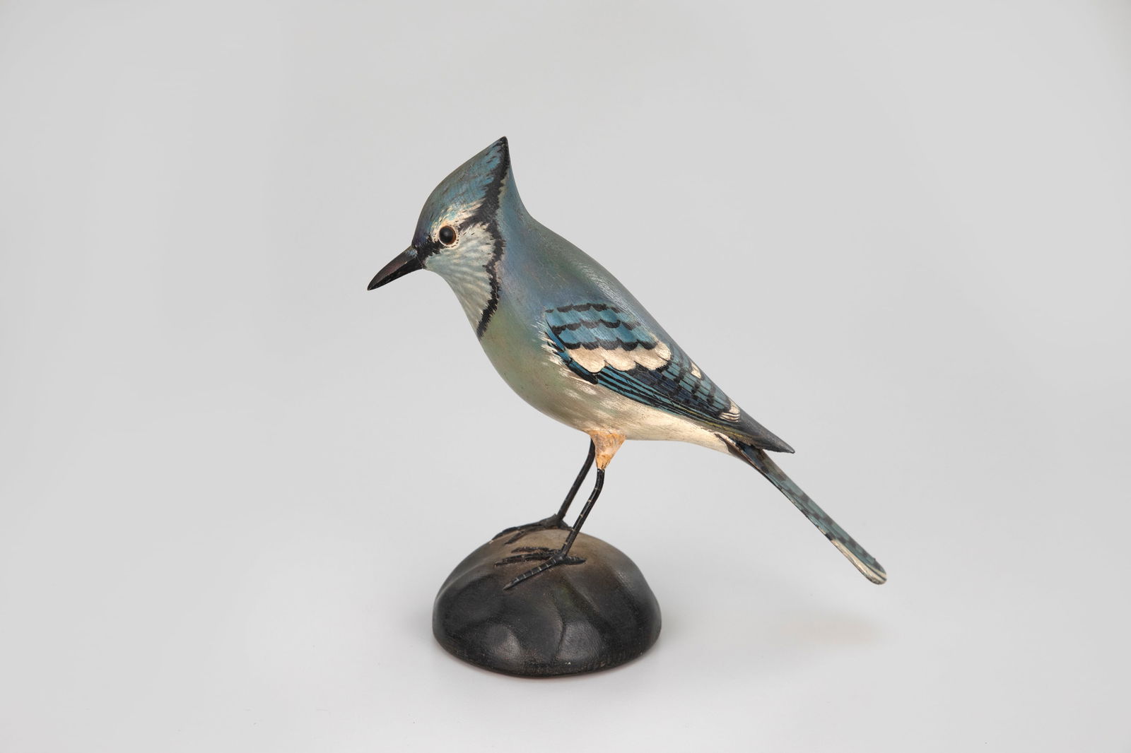 Blue Jay by A. Elmer Crowell (1862-1952): Blue Jay A. Elmer Crowell (1862-1952) East Harwich, MA, c. 1925 7 3/4 in. tall An exceptional early and rare blue jay carving with an ink signature and oval brand on the underside. This example displa