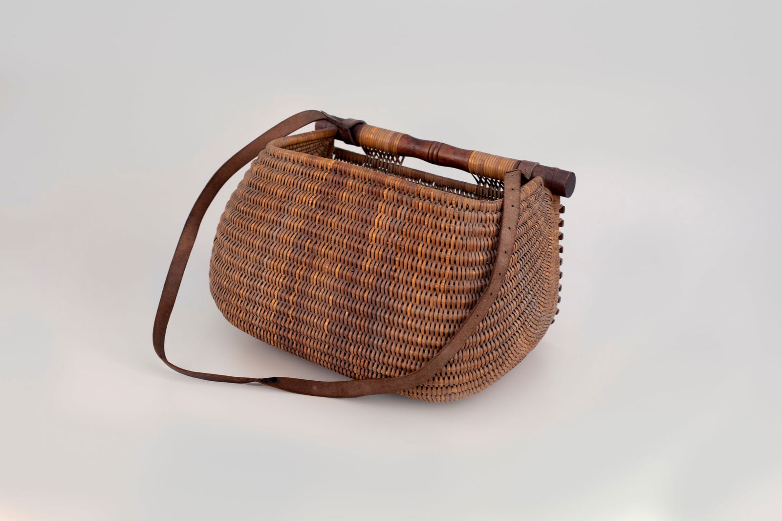 Outstanding Nantucket Creel or Basket: Outstanding Nantucket Creel or Basket 9 1/2 in. tall, 15 in. wide This traditional fishing or food basket with leather strap displays the classic weave from its native island home. Provenance: