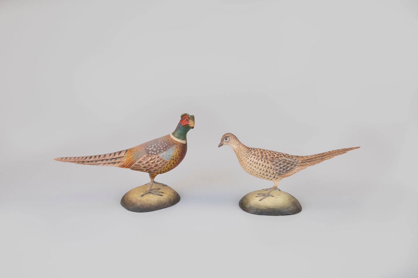 Miniature Pheasant Pair by Frank Finney (b. 1947): Miniature Pheasant Pair Frank Finney (b. 1947) Capeville, VA 8 in. long Both bear carved feather detail and the maker's serifed "F" and "Finney" ink stamp signatures on the undersides of the bases.
