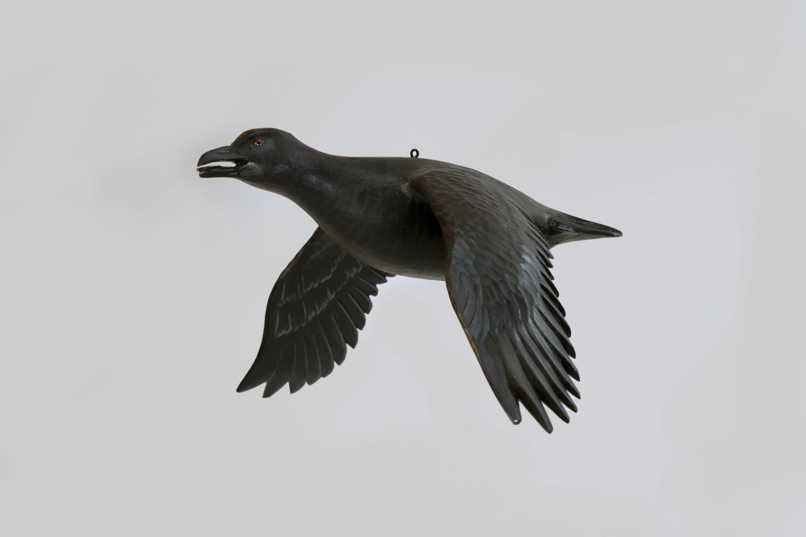 Rare Flying Raven Carving by Mike Borrett (b. 1960): Rare Flying Raven Carving Mike Borrett (b. 1960) Madison, WI 24 in. wingspan This work has textured feather detail, an incised tail, an open bill, and the maker's incised "BORRETT" on the back. The