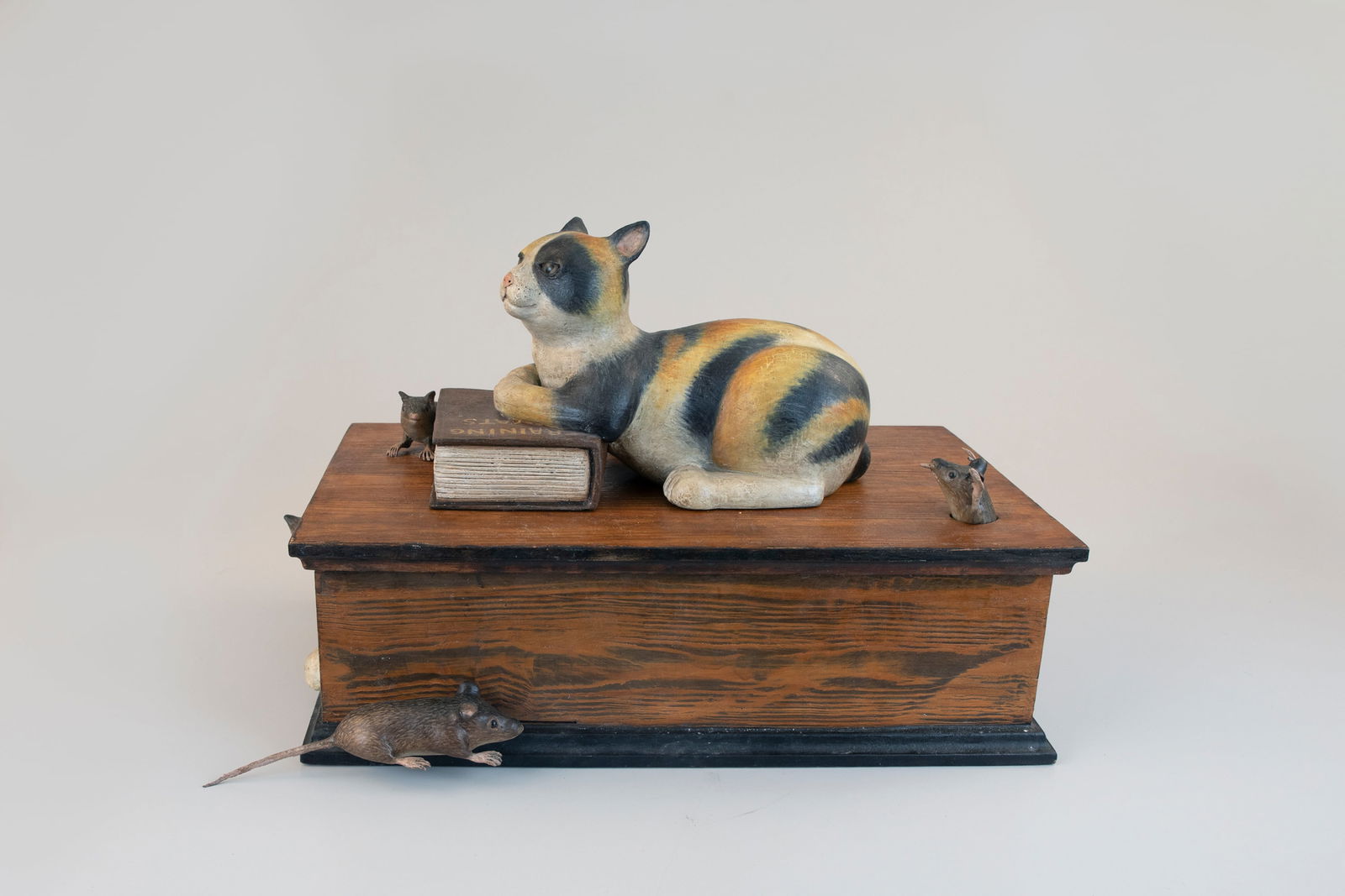 "Training Cats" Mechanical Box by Frank Finney (b. 1947): "Training Cats" Mechanical Box Frank Finney (b. 1947) Capeville, VA 17 1/2 in. long, 12 in. tall, 12 in. wid This playful work depicts five mice toying with one feline, which is reclining on a book en