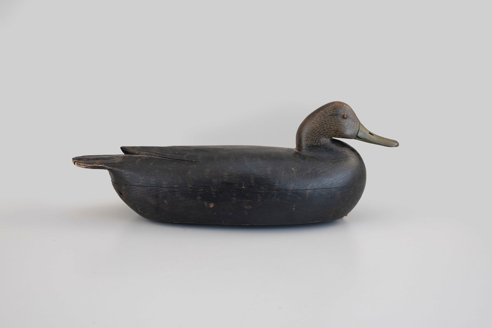 Black Duck by Tom Fitzpatrick (1887-1958): Black Duck Tom Fitzpatrick (1887-1958) Delanco, NJ, c. 1930 16 in. long A hollow Delaware River decoy with a tucked head. Original paint with even gunning wear, some wear around body seam nails. 