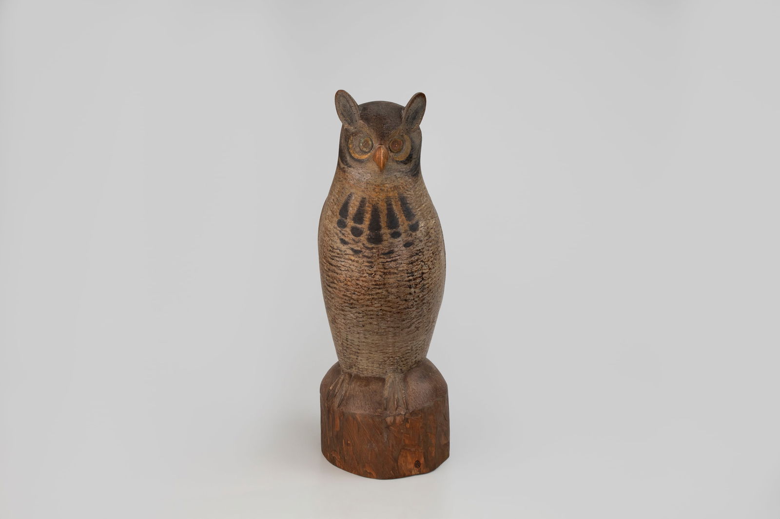 Great Horned Owl by Mark McNair (b. 1950): Great Horned Owl Mark McNair (b. 1950) Craddockville, VA, 2019 23 in. tall on base A rare live-size owl decoy carved from a single cedar log with subtle details. The ears, or plumicorns, are faced