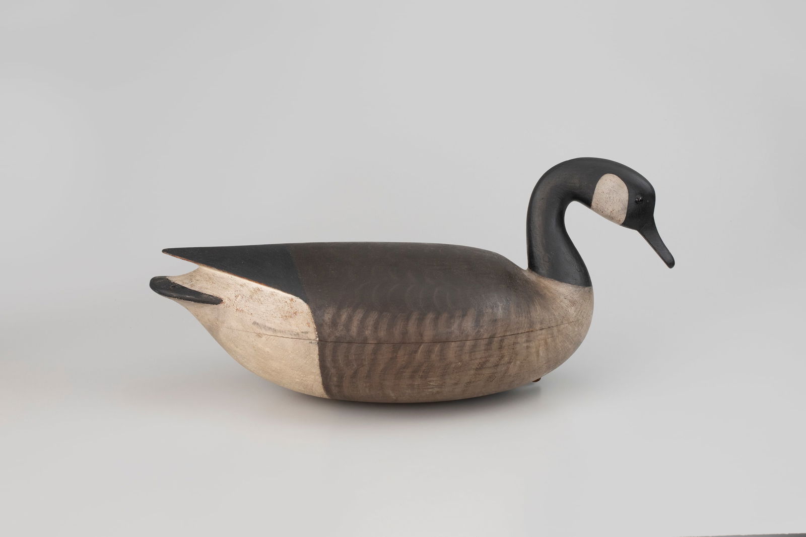 Canada Goose by Mark McNair (b. 1950): Canada Goose Mark McNair (b. 1950) Craddockville, VA, c. 1995 27 in. long This grand carving appears to be modeled after the giant Canada goose subspecies. It bears the maker's incised "M.S. McNair" s