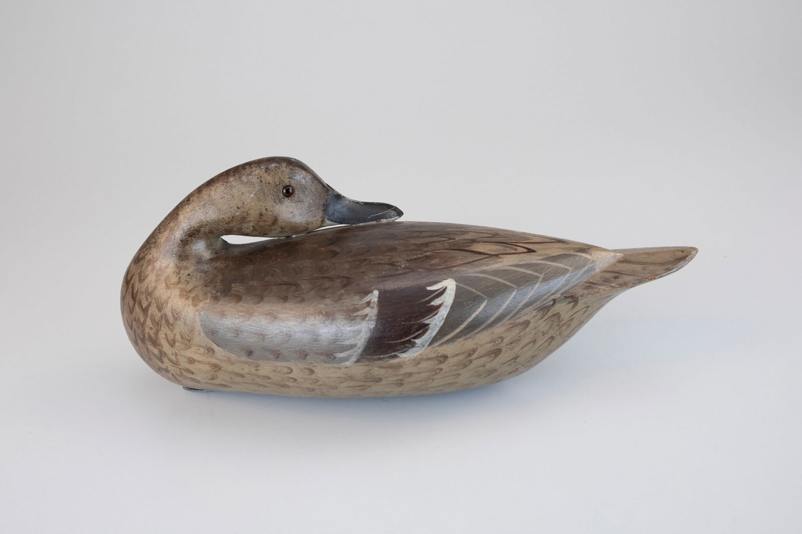 The Masterworks Preening Pintail Hen by Charles H. Perdew (1874-1963): The Masterworks Preening Pintail Hen Charles H. Perdew (1874-1963) Henry, IL, c. 1925 14 1/4 in. long "This graceful decoy is rare," writes "Perdew" author Ann Lacy of the nearly identical rigmate and