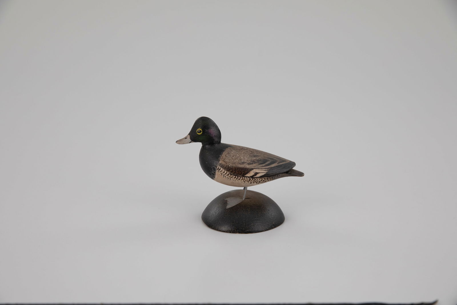Miniature Bluebill Drake by A. Elmer Crowell (1862-1952): Miniature Bluebill Drake A. Elmer Crowell (1862-1952) East Harwich, MA, c. 1935 3 in. tall Signed by the maker on the bottom of the base with his rectangular stamp. Original paint with light wear.