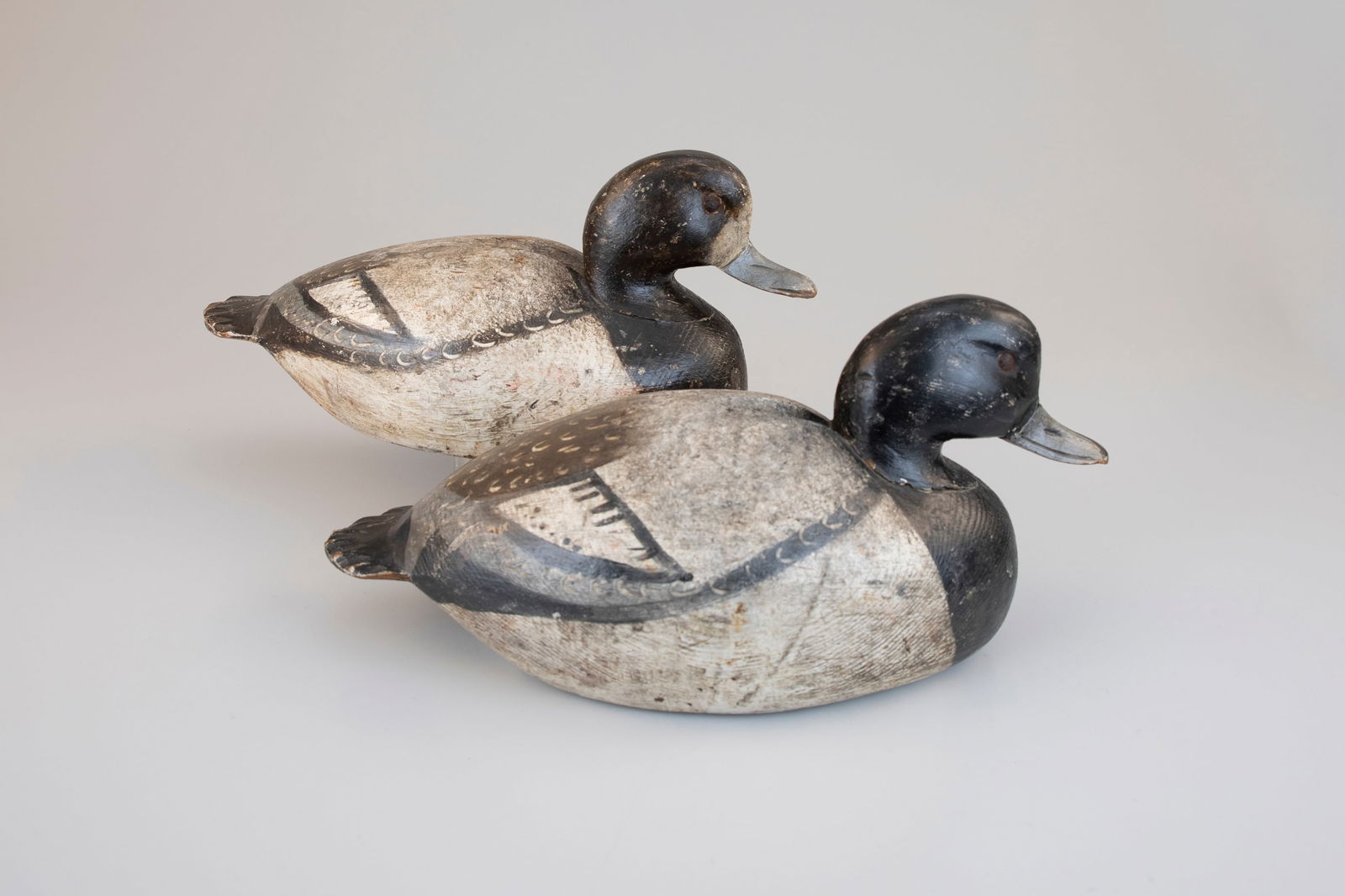 Bluebill Pair by Ira D. Hudson (1873-1949): Bluebill Pair Ira D. Hudson (1873-1949) Chincoteague, VA, c. 1930 13 1/2 in. long A bold and exemplary bluebill pair with expressive head carving and fluted "banjo" tails. Each grand body was made