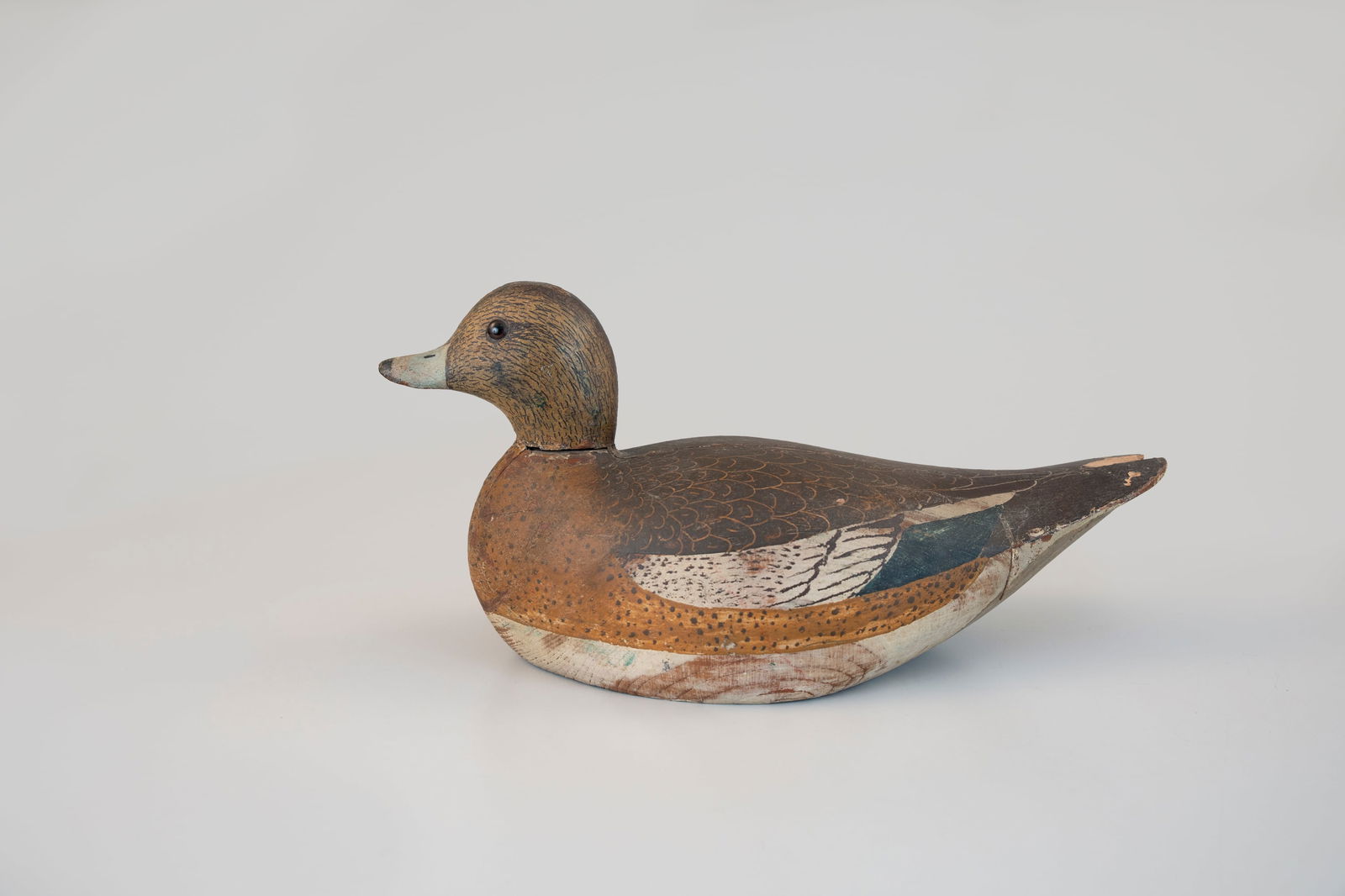 Wigeon Hen by Lloyd Aaron Sterling (1880-1964): Wigeon Hen Lloyd Aaron Sterling (1880-1964) Crisfield, MD, c. 1920 14 1/2 in. long A boldly carved wigeon with a well-sculpted beavertail body and upturned head. The head and back display