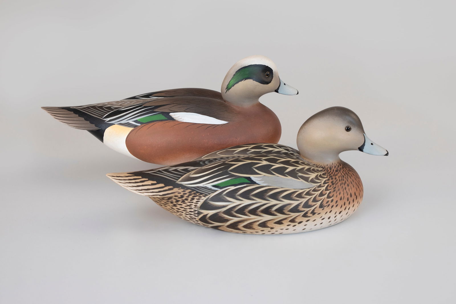 Wigeon Pair by Oliver "Tuts" Lawson (b. 1938): Wigeon Pair Oliver "Tuts" Lawson (b. 1938) Crisfield, MD, 1981 13 1/2 in. long The carvings bear the maker's signature and date on the bottoms. Original paint with light wear.