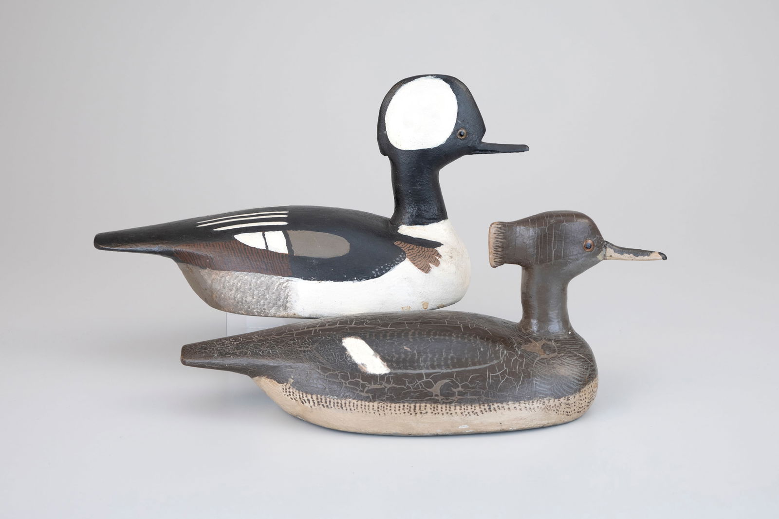 Rare Hooded Merganser Pair by William "Billy" Ellis (1865-1963): Rare Hooded Merganser Pair William "Billy" Ellis (1865-1963) Whitby, Ontario, Canada, c. 1940 14 1/2 in. long Original paint with even wear and the hen has craquelure. Literature: Bernie Gates, "Ontar
