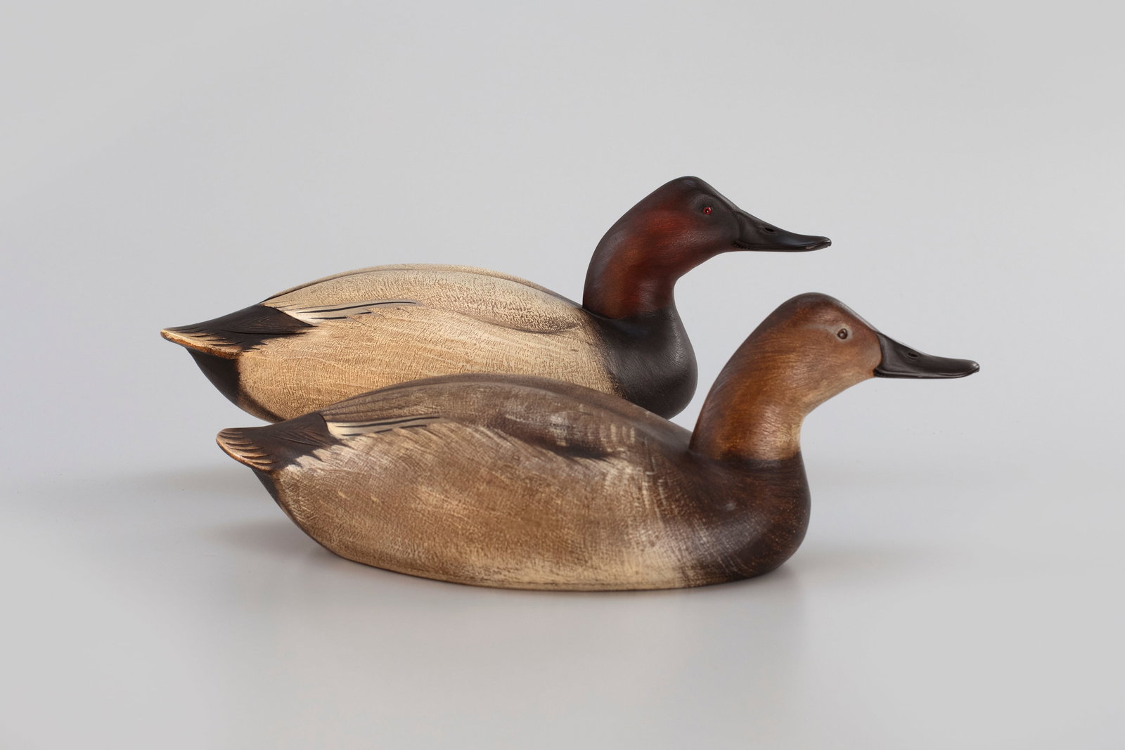 Canvasback Pair by Jim Schmiedlin (1945-2015): Canvasback Pair Jim Schmiedlin (1945-2015) Bradford Woods, PA, 1991 18 in. long The undersides bear the maker's "JAS" brand, date and inked signature. Original paint with light wear. Provenance: Rober