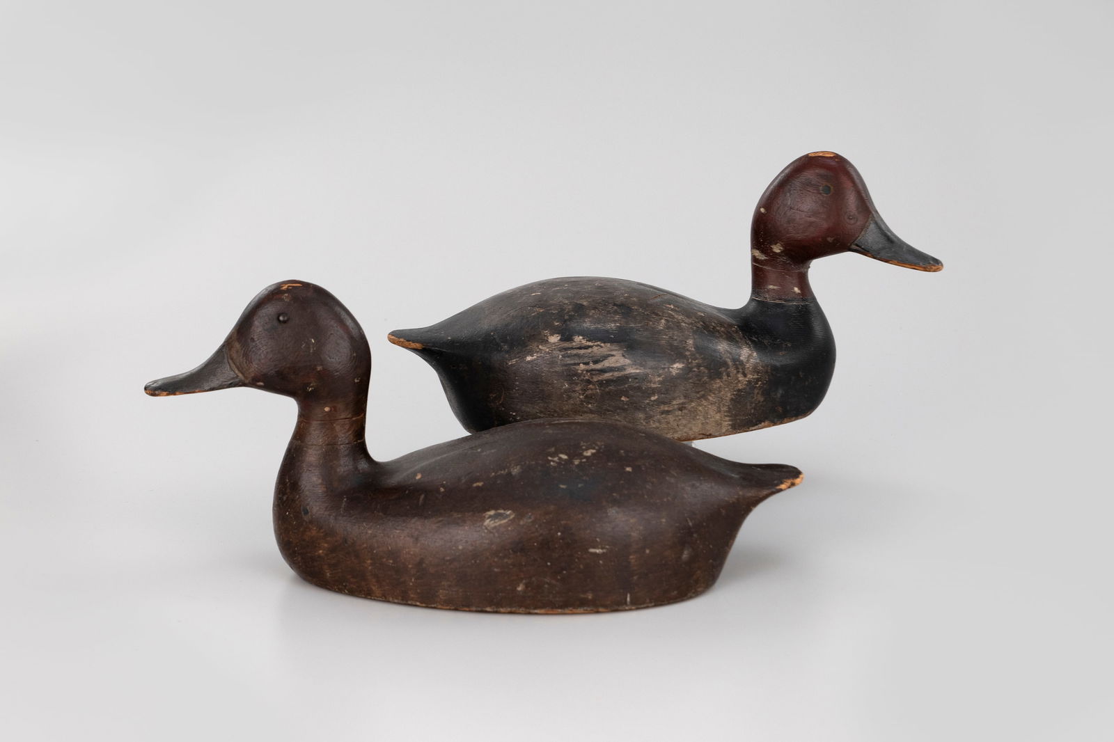 Redhead Pair by Captain Adam Hartung (1860-1909): Redhead Pair Captain Adam Hartung (1860-1909) Sandusky, OH, c. 1890 15 in. long The hen is hollow. Appears to be mostly original paint with gunning wear. Both have neck cracks, and gunning repaint