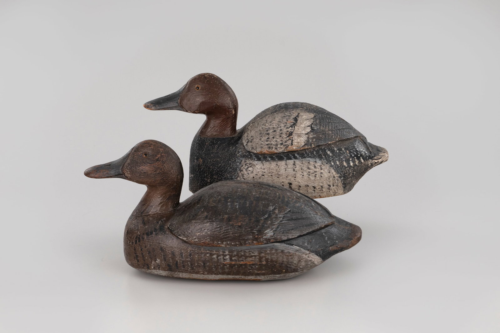 Hump-Back Redhead Pair by John "Jack" Rider (1881-1967): Hump-Back Redhead Pair John "Jack" Rider (1881-1967) Port Clinton, OH, c. 1940 15 in. long A bold pair with incised, crossed wing tips and the maker's painted signature on the undersides. Original