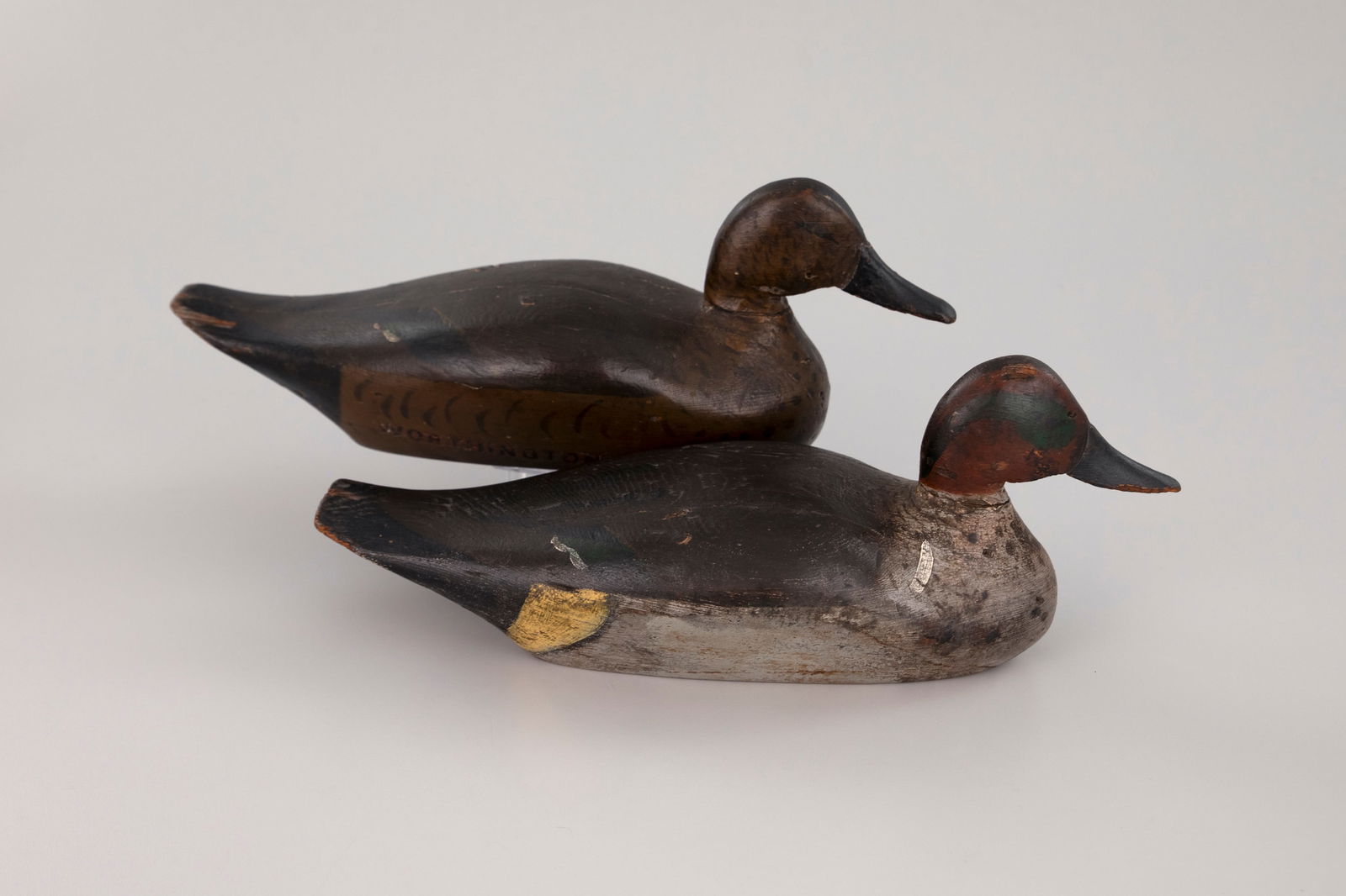 Early Green-Winged Teal Pair by J. N. Dodge Factory (1883-1893): Early Green-Winged Teal Pair J. N. Dodge Factory (1883-1893) Detroit, MI, c. 1885 12 in. long A rare and early well-matched pair of sharp-chined decoys with upswept tails. The hen has a "Worthington"