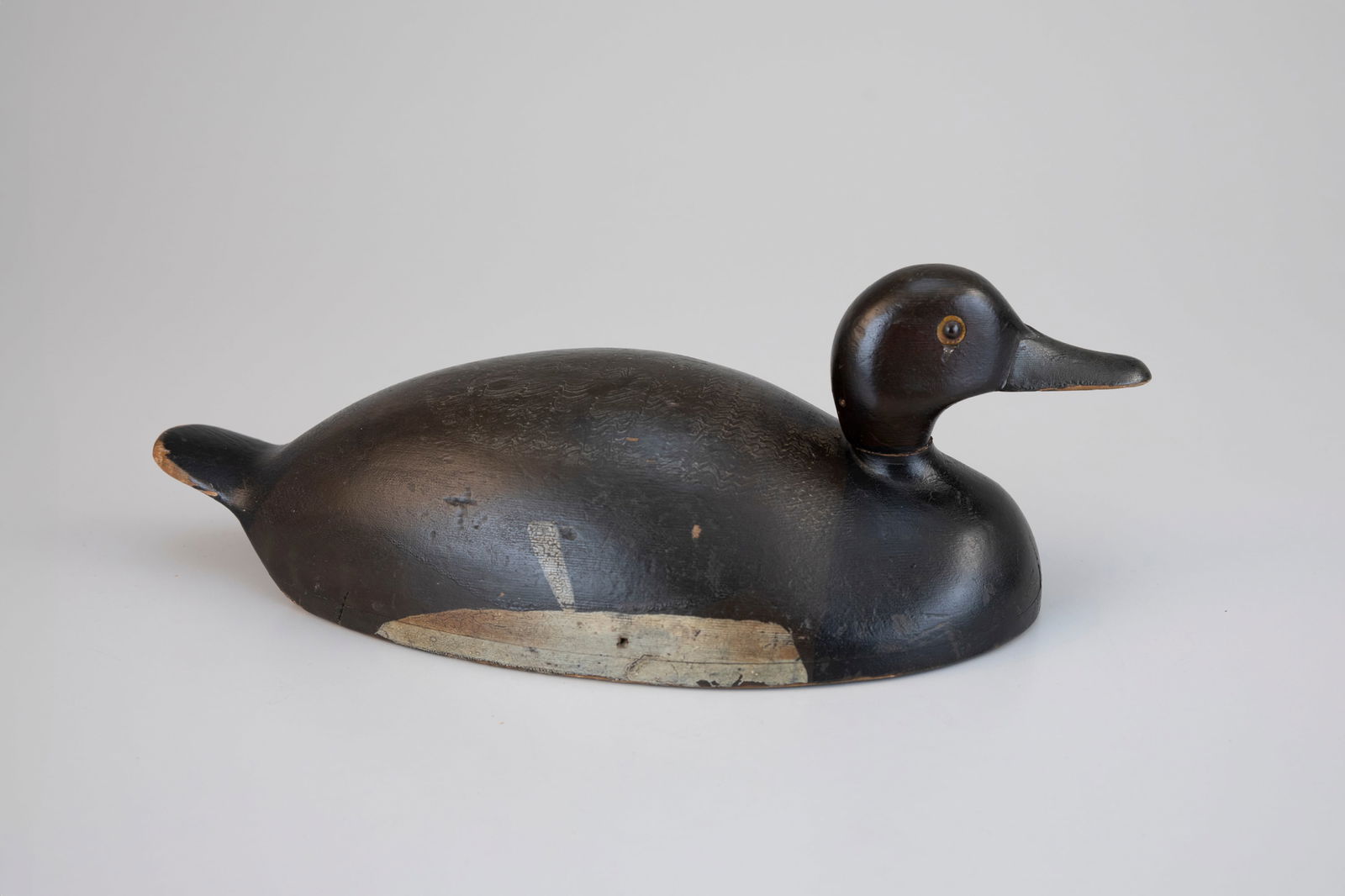 Hollow Redhead by Dan Bartlett (1839-1936): Hollow Redhead Dan Bartlett (1839-1936) Prince Edward County, Ontario, c. 1900 14 in. long A very hollow humpback decoy with a thin upswept tail. Original paint with even gunning wear and original