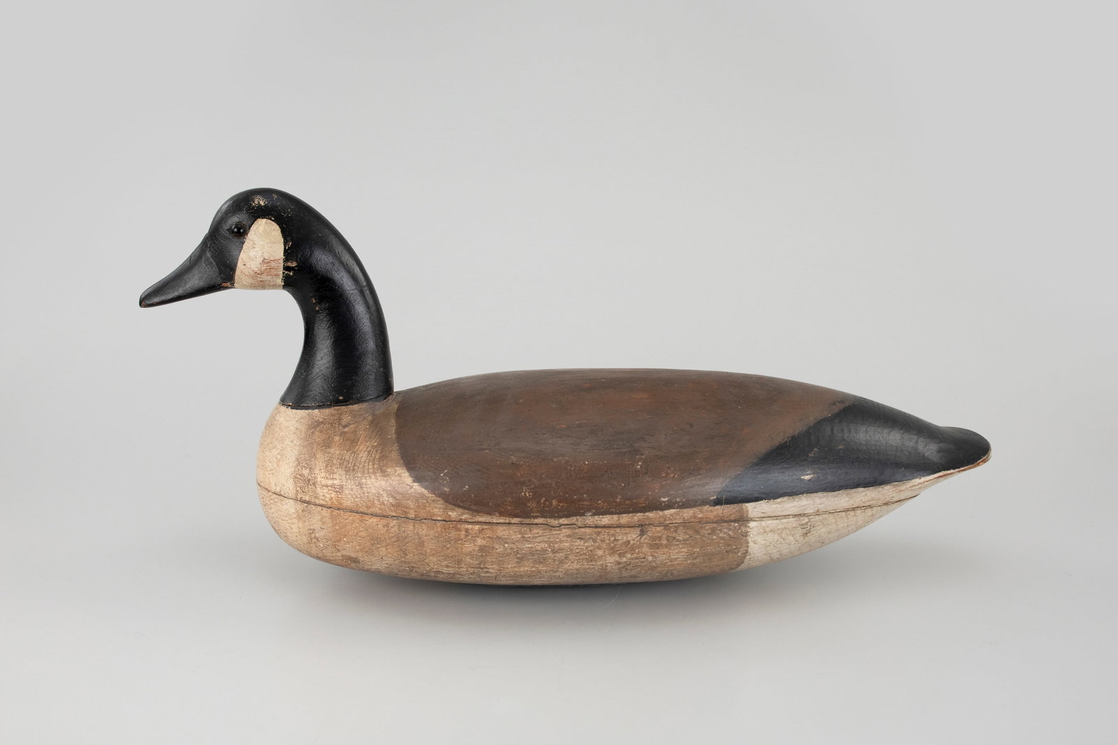 Canada Goose Decoy, Ellis Parker (1870-1952): Canada Goose Decoy Ellis Parker (1870-1952) Parkertown, NJ 23 in. long A well-rounded hollow goose with clean lines. A mixture of original and working paint with even wear and an old reset neck. Touch