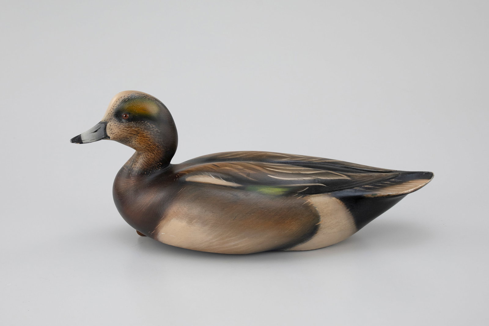 Wigeon Decoy, Sean Sutton (b. 1967): Wigeon Decoy Sean Sutton (b. 1967) Paulsboro, NJ 15 1/2 in. long The underside of the hollow body is signed and its weight is stamped. Original paint with light wear. Provenance: Matt Geis Collection