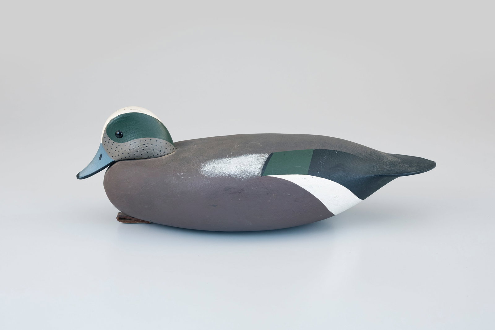 Wigeon Decoy, James P. "Jamie" Hand (b. 1953): Wigeon Decoy James P. "Jamie" Hand (b. 1953) Cape May, NJ 15 in. long A snuggle-head hollow wigeon with the maker's brand on the underside. Original paint with light wear.