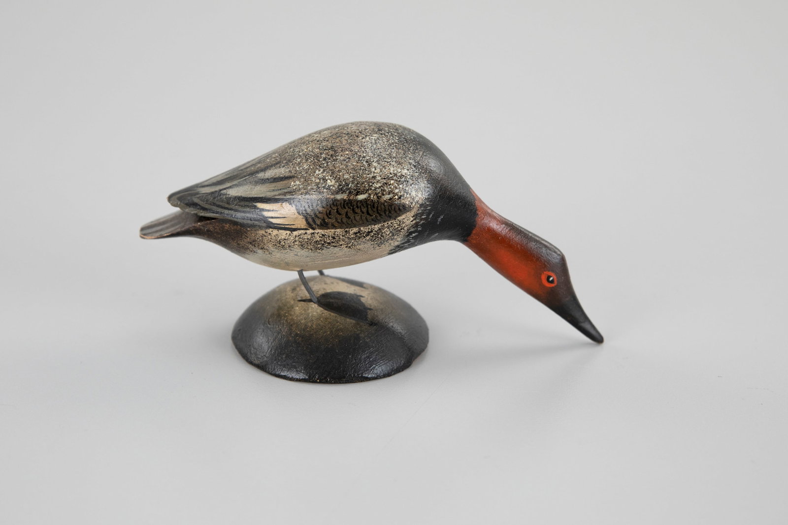 Outstanding Miniature Feeding Canvasback by A. Elmer Crowell (1862-1952): Outstanding Miniature Feeding Canvasback A. Elmer Crowell (1862-1952) East Harwich, MA, c. 1920 5 in. long Signed with the "Maker" ink stamp. Original paint with light wear.