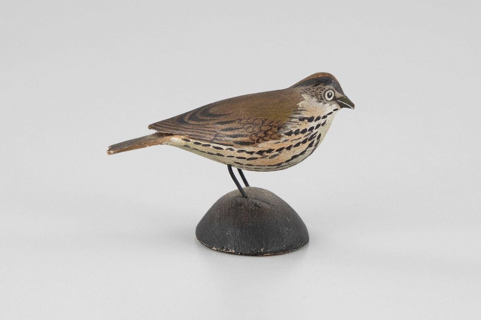 Early Miniature Ovenbird by A. Elmer Crowell (1862-1952): Early Miniature Ovenbird A. Elmer Crowell (1862-1952) East Harwich, MA, c. 1923 2 3/4 in. long The base has Crowell's blue-paper label. Lots 362 through 373 are from a single set that has remained in 