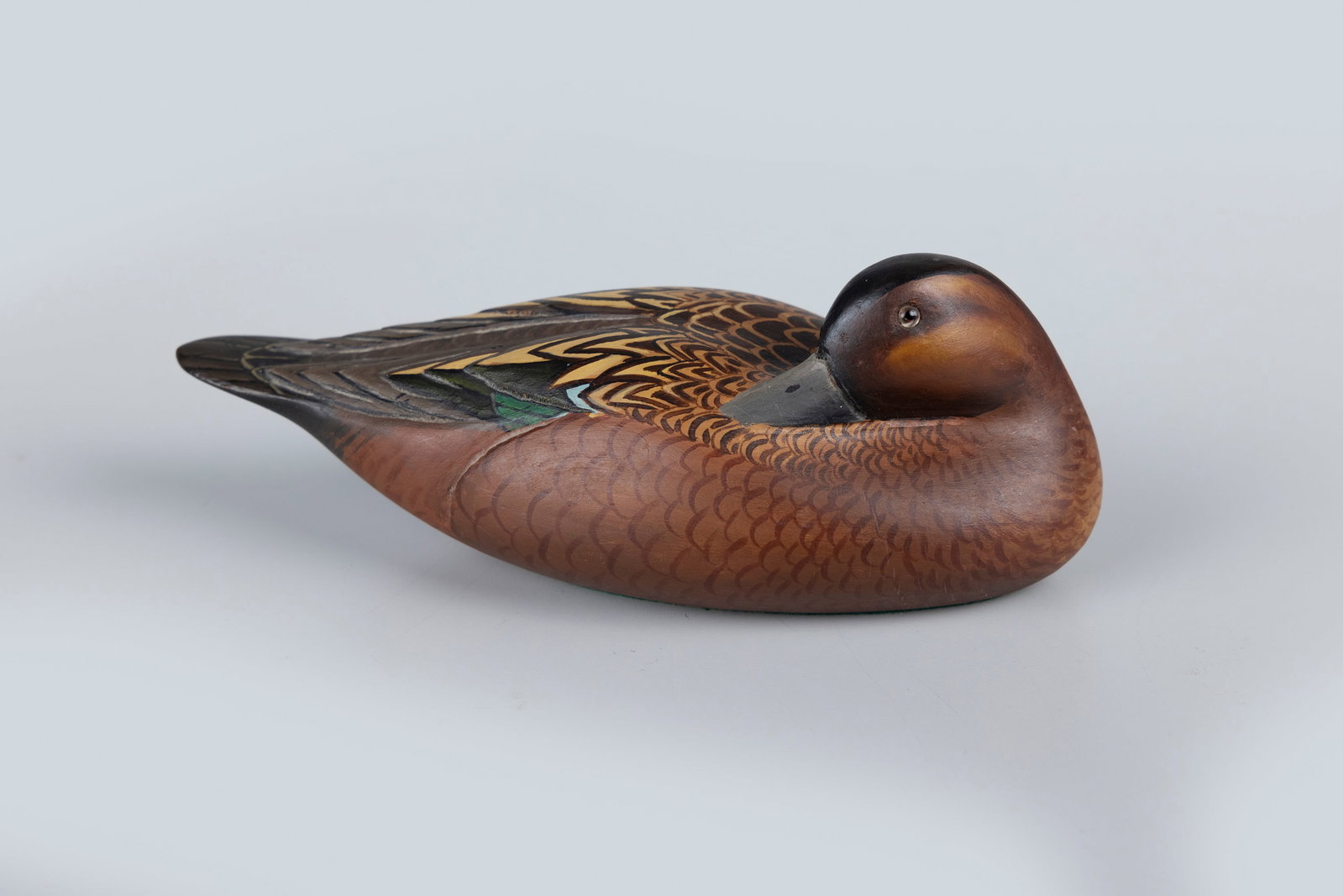 Cinnamon Teal Decoy: Cinnamon Teal Decoy 10 in. long A sleeping cinnamon teal carving by an unidentified maker. Original paint with light wear. Provenance: Estate of Edwin Schultz