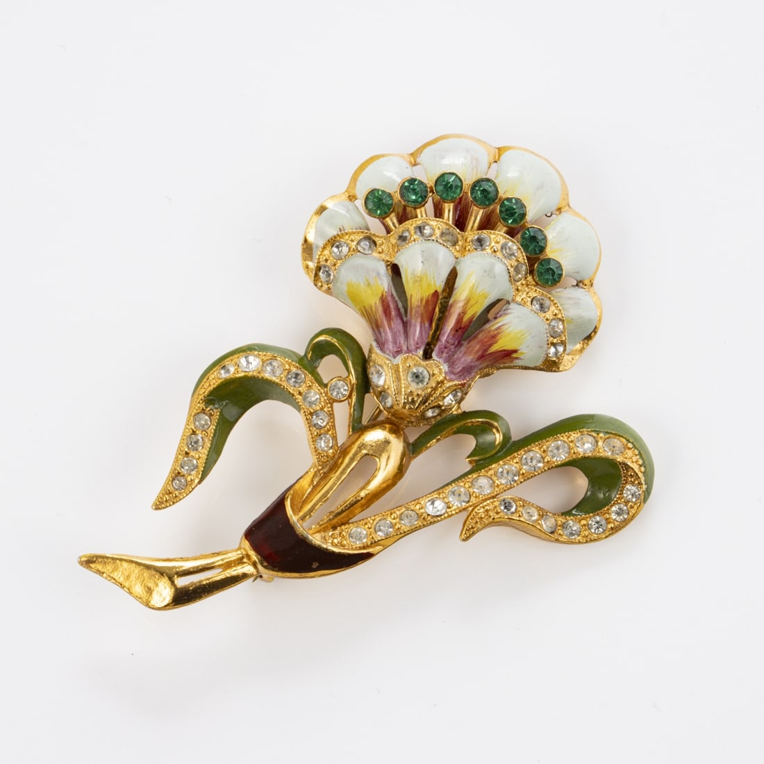 CORO - Vintage Blumenbrosche: CORO - Vintage BlumenbroscheCoro Cohn & Rosenberger Jewelry, New York, USA. Ca. 1950er Jahre. Metall, goldfarben, gruene und klare Strasssteine, Emaille. Nadel mit Sicherheitsschieber. Masse: 8,5 x 5,