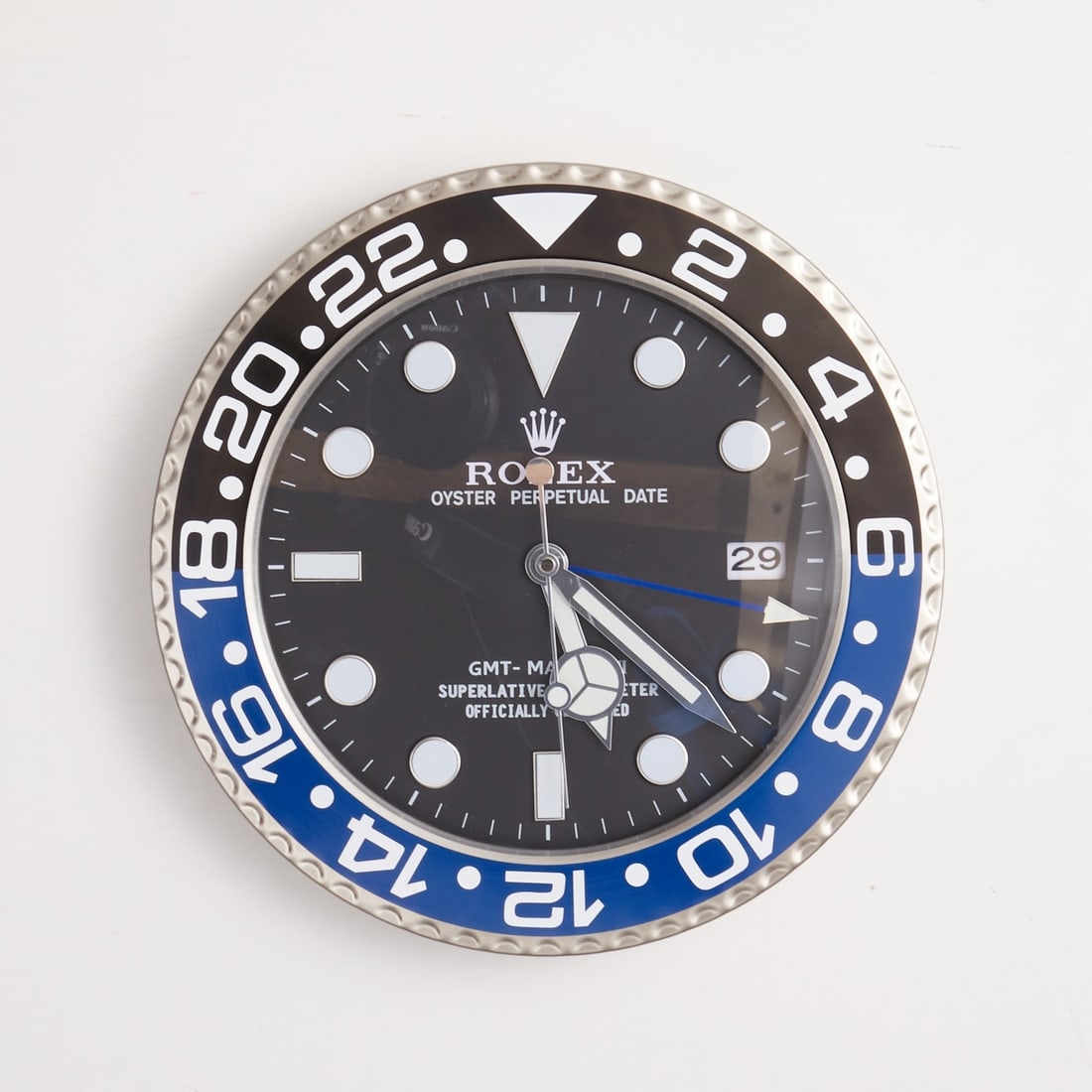 Rolex - Wall Clock: Rolex - Wall Clock Model: GMT-Master II Batman XL. Stainless steel, stamped. D. 33.5 cm. Clock is as new and functional. Quartz movement. Black dial with black-blue bezel. Functions: Hour, Minute, Cen