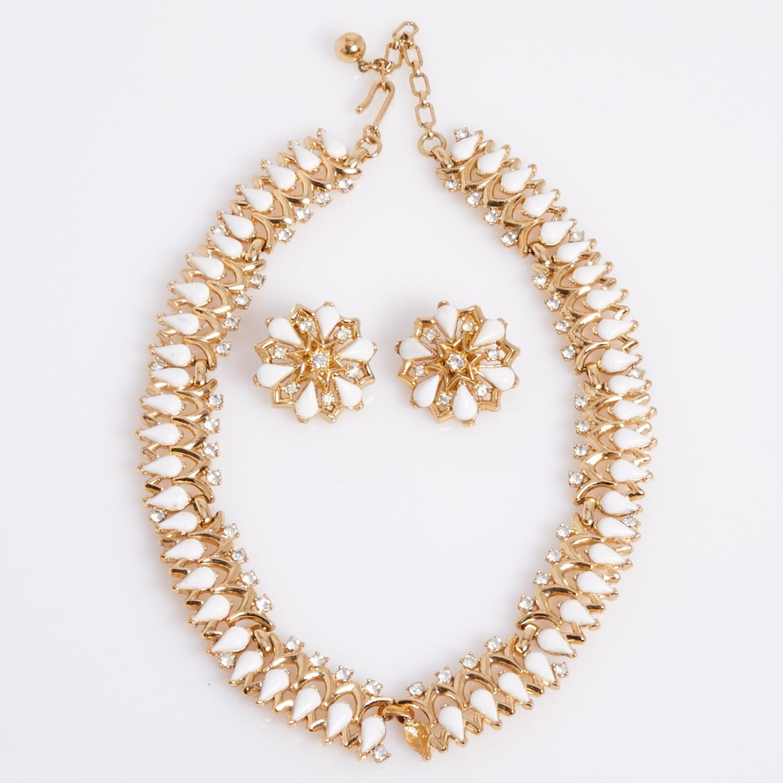 TRIFARI Alfred Philippe - Vintage Glass Drop Necklace and Pair of Ear Clips (2 pieces): TRIFARI Alfred Philippe - Vintage Glass Drop Necklace and Pair of Ear Clips (2 pieces) Crown Trifari, New York, circa 1950. Metal, gold-colored with small rhinestones and white glass drops. Total weig