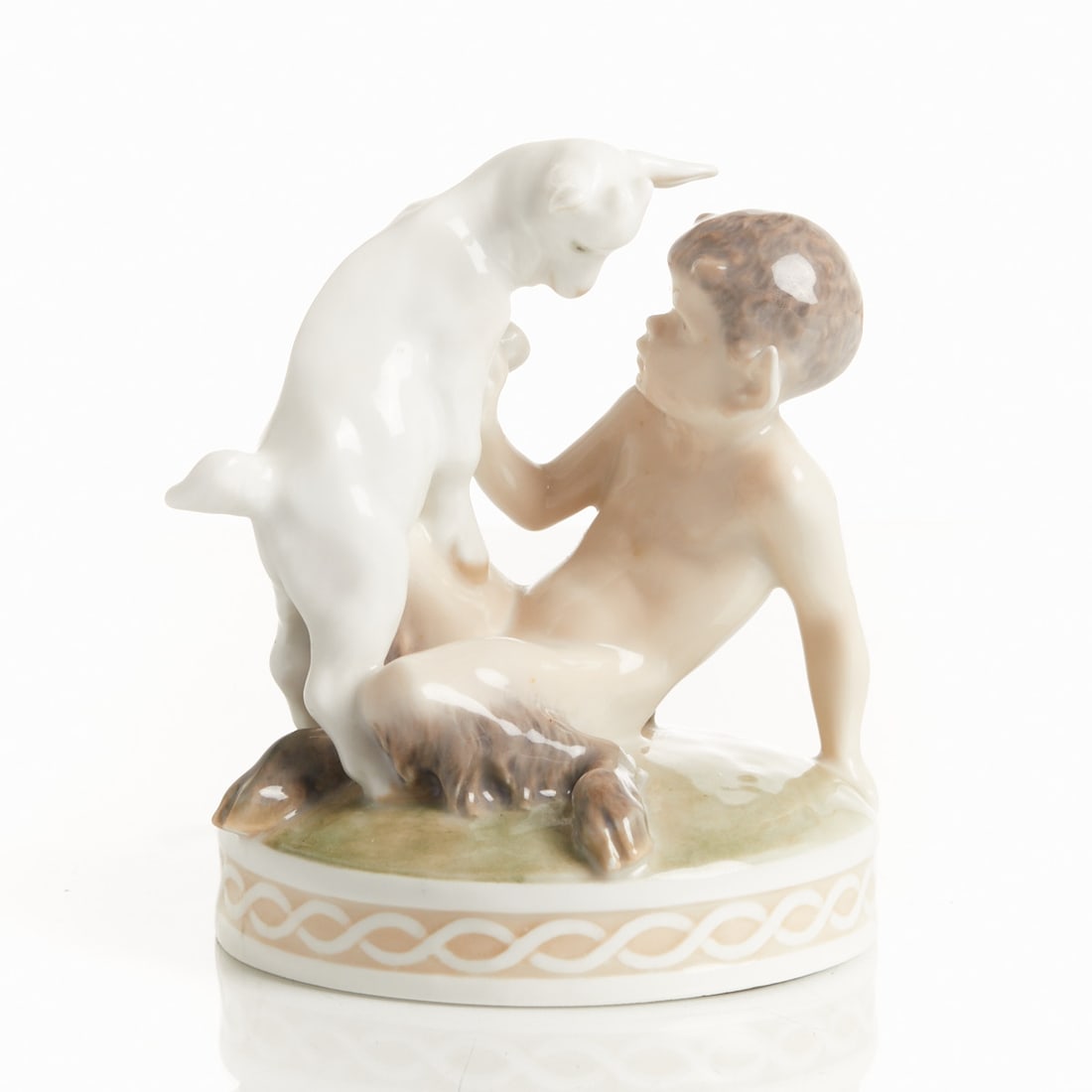 Faun with Kid - Christian Ludvig Thomsen, Royal Copenhagen, circa 1905-1922: Faun with Kid - Christian Ludvig Thomsen Royal Porcelain Manufactory, Copenhagen circa 1905-1922. Porcelain, white, glazed. Underglaze polychrome pastel-toned painting. Underglaze green mark and three