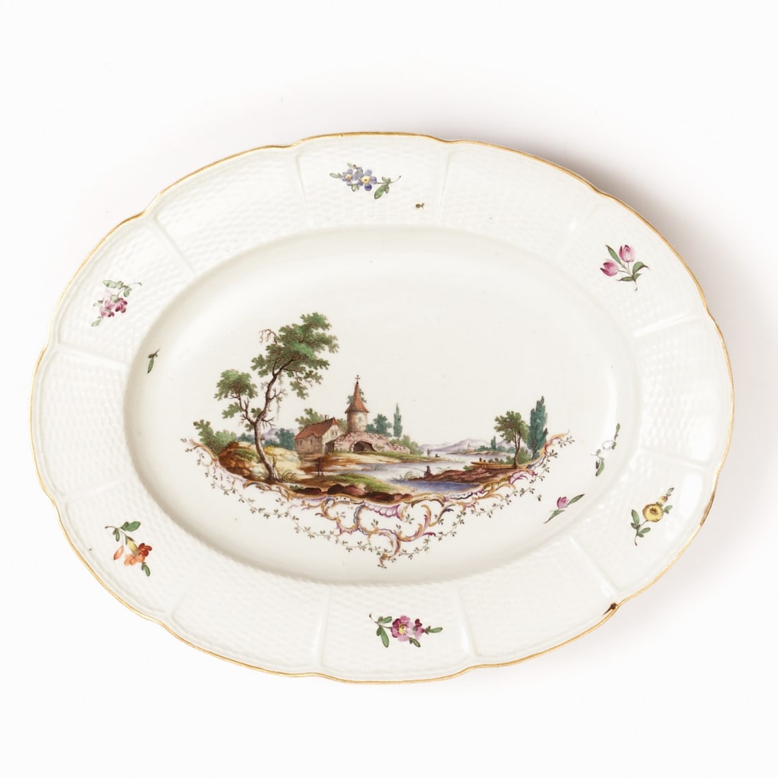 Oval Plate - Altozier: Landscape with Angler on a Rocaille Base. Ludwigsburg circa 1765.: Oval plate - Altozier: Landscape with an angler on a rocaille base. Ducal Royal Porcelain Factory, Ludwigsburg circa 1765. Porcelain, white, glazed. Polychrome and gold painted. Gold rim. Blue mark un