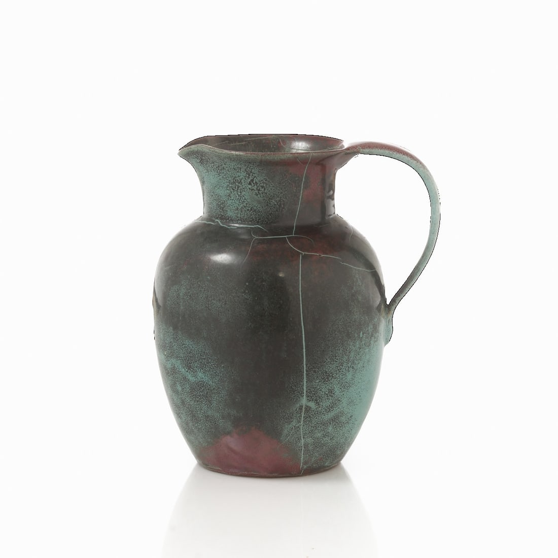 Handled jug. Richard Uhlemeyer, Hanover.: Handled jug Richard Uhlemeyer, Hanover. Light stoneware. Black-Green-Red reduction glaze. Unmarked. H. 20.5 cm. - Lit.: Compare exhibition catalog. Ceramic Handicraft Richard Uhlemeyer Hanover