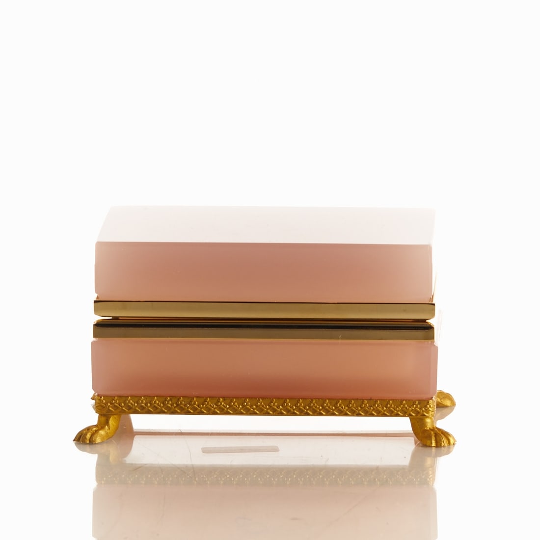 Rectangular lidded box on mounting with lion's feet - Art Déco. France, circa 1935-1940.: Rectangular lidded box on mounting with lion's feet - Art Déco France, circa 1935-1940. Thick-walled, light pink opal glass, slightly translucent, cut and polished. Brass mounting with hinge. E
