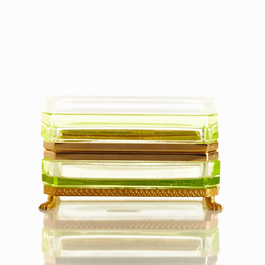 Octagonal lidded box on a mounting with lion's feet - Art Deco. France, circa 1935-1940.: Octagonal lidded box on a mounting with lion's feet - Art Deco France, circa 1935-1940. Uranium glass: Thick-walled, green glass (apple green), ground and polished. Brass mounting with hinge. Decorate