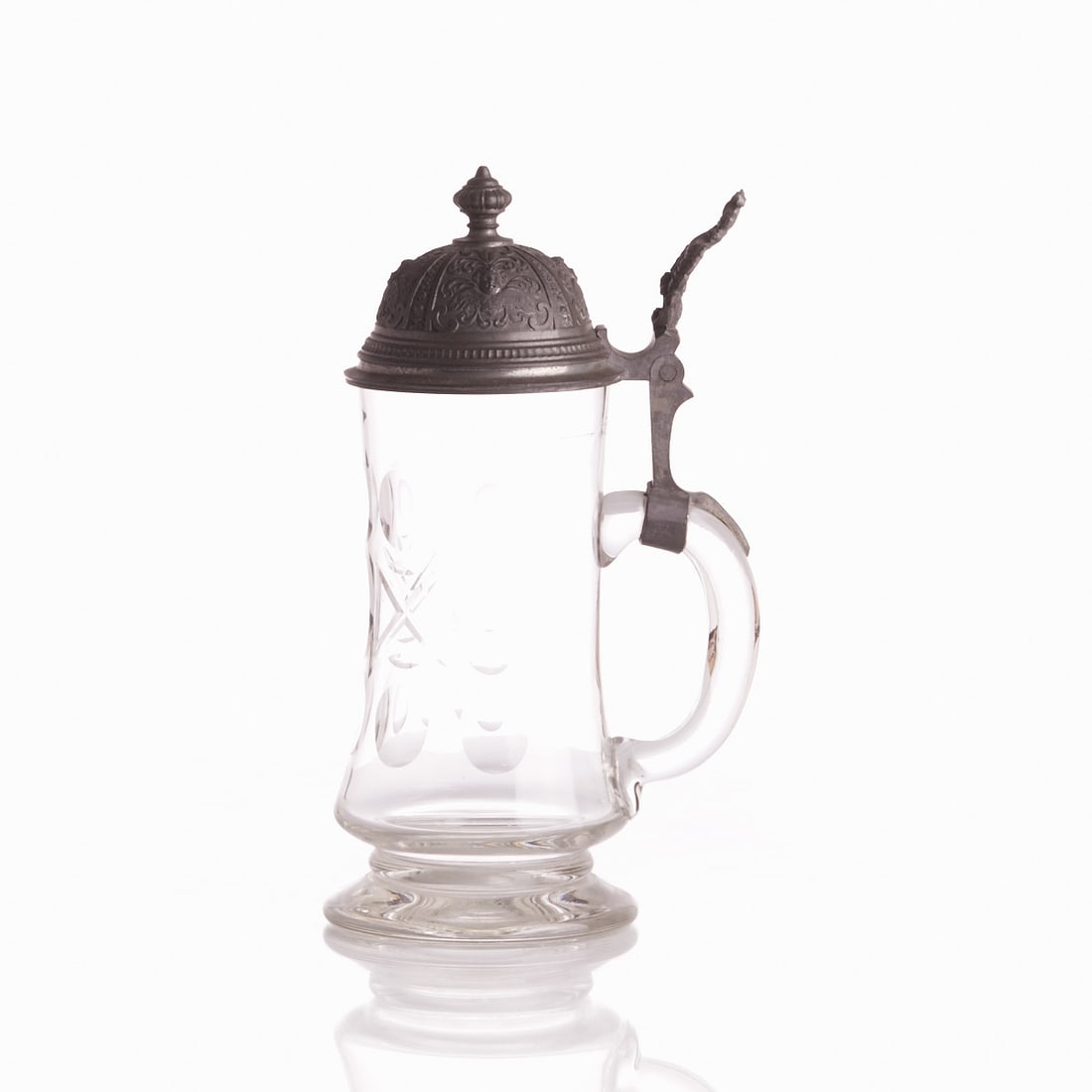 Jug - Pewter Lid with Putti.: Jug - Pewter Lid with Putti Colorless glass, with three rows of circles, ovals and crosses ground into it. Fill line 0.5L. Pewter mount with rocaille thumb rest and domed pewter lid with four putti. H