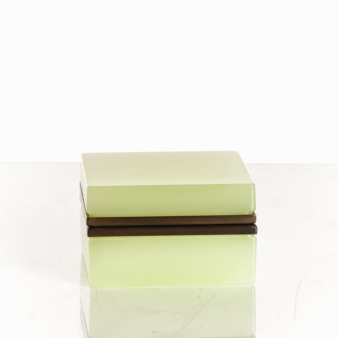 Square Covered Box - Art Deco. France, circa 1935-1940.: Square Covered Box - Art Deco France, circa 1935-1940. Uranium glass: Thick-walled, yellow-green opal glass (apple green), cut and polished. Anthracite-colored metal mounting with hinge. H. 6 cm, 9.5