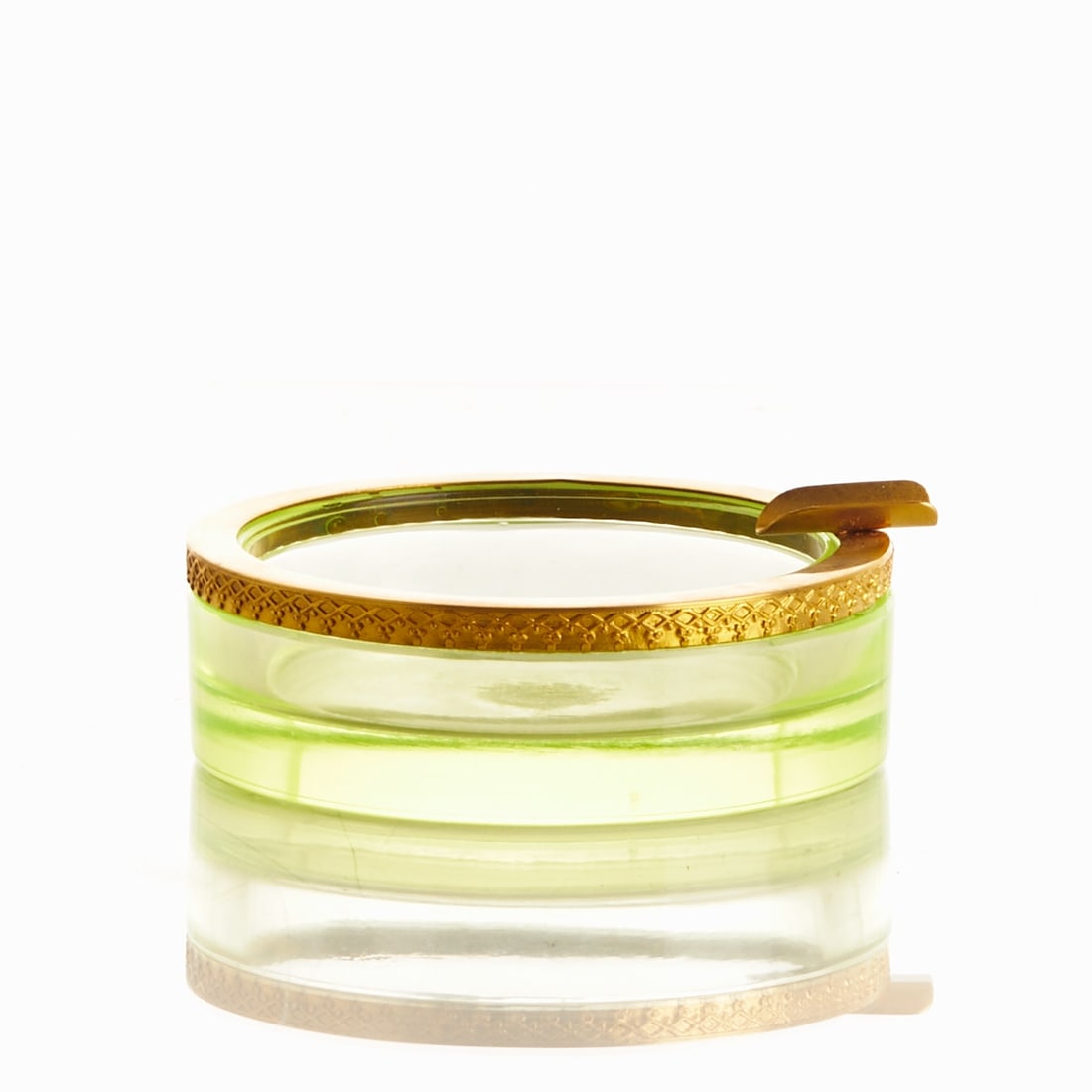 Round Ashtray - Art Deco. France, circa 1935-1940.: Round Ashtray - Art Deco France, circa 1935-1940. Uranium glass: Thick-walled, green glass (apple green), cut and polished. Decorated brass mounting with a tray. H. 3.5 cm, D. 9 cm.