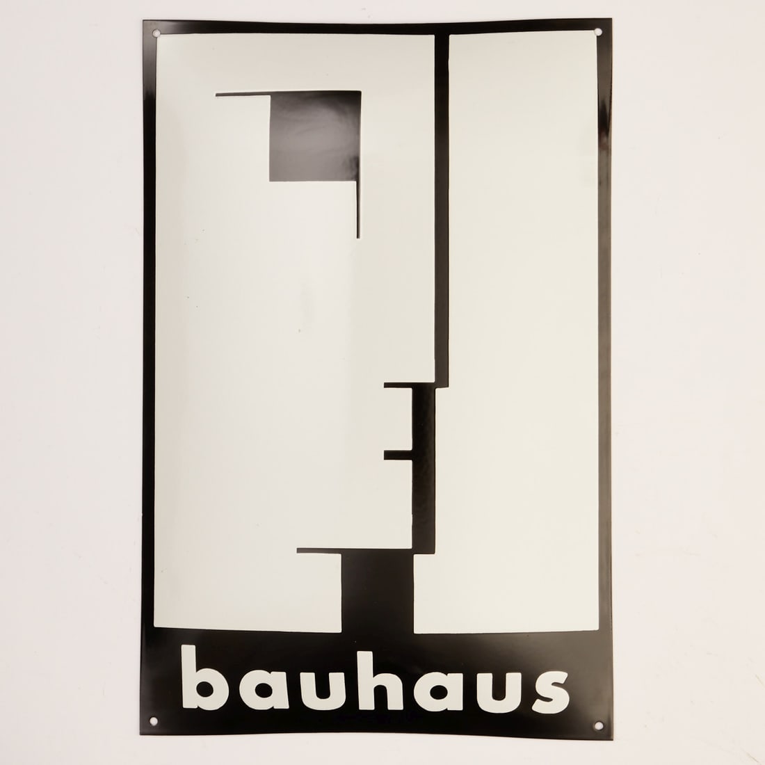 Enamel sign "bauhaus" Black/White: Enamel sign "bauhaus" Black/White. Germany, 20th century. Black and white enamel on steel sheet, curved. 60 x 39.5 cm. Black and white graphic with geometrically abstracted figure, lettering at the