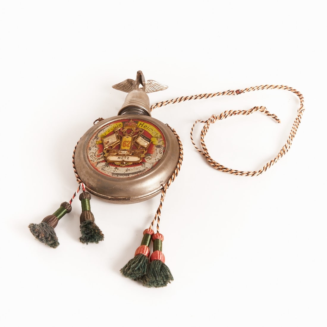 Reservist's Flask - Metz / Alsace-Lorraine: Reservist's Flask / Commemorative Field Flask Germany (Alsace-Lorraine), circa 1900. Round metal flask with screw cap and applied eagle as a finial. D. approx. 12 cm. On the front, a colorfully