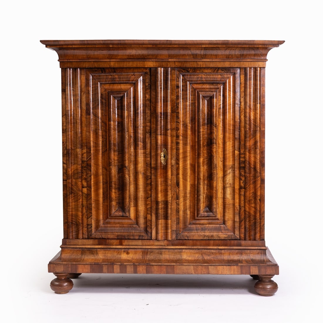 Wavy Cabinet: Wavy CabinetFrankfurt, 18th century. Walnut. 197 x 187 x 78.5 cm. Requires restoration. The two-door body with its characteristic multi-undulated front rises on four squat ball feet with a straight
