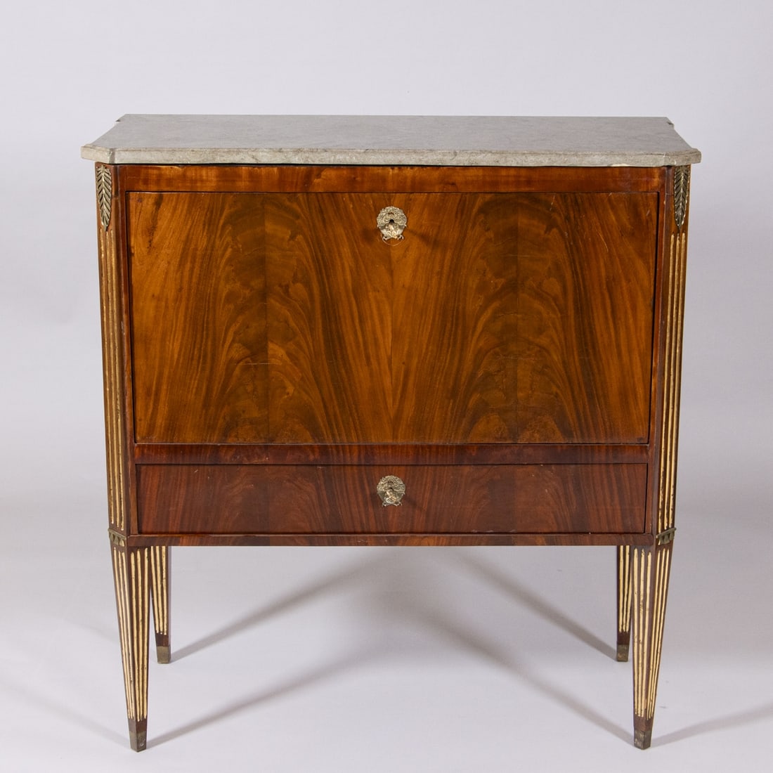 Louis XVI Secretary: Louis XVI SecretaryFrance, circa 1800. Mahogany. Marble. 117 x 109 x 49 cm. Restored. On four conical, fluted legs. Rectangular, canted body with one drawer and a writing surface. Behind the writing