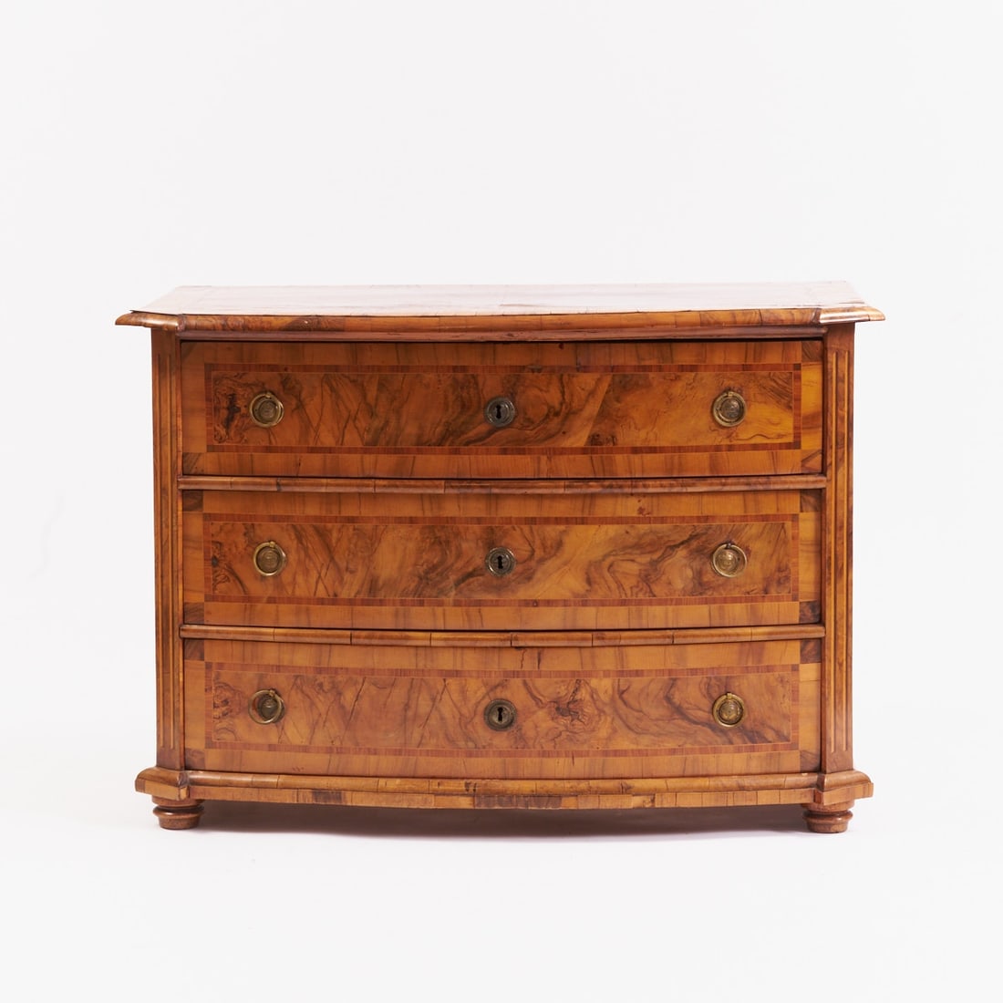 Baroque Commode: Baroque CommodeGermany, circa 1760. Walnut. Fruitwood. 85 x 122 x 66 cm. Requires restoration. On four squat feet. Bombe body with three drawers. Richly decorated with band inlays. Finished with a